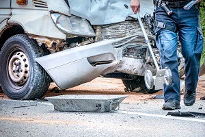 A totaled car in the aftermath of an accident with a semi, where a Truck Accident Attorney in Peoria IL is needed