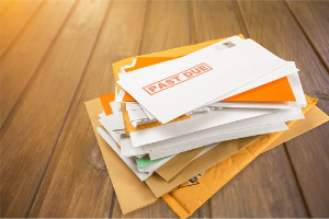A pile of bills from a person who needs to learn How to File for Bankruptcy in Peoria IL